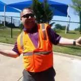 Steven R. Beck outdoors in an orange reflective safety vest